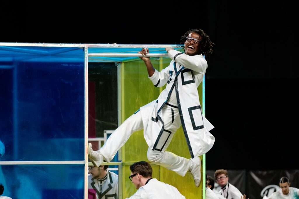 Member climbing on boxes | 2025 Bluecoats